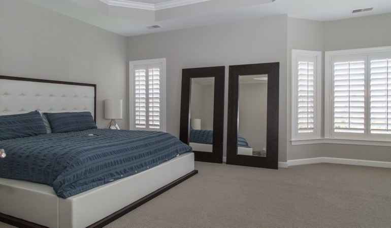 Polywood shutters in a minimalist bedroom in Salt Lake City.